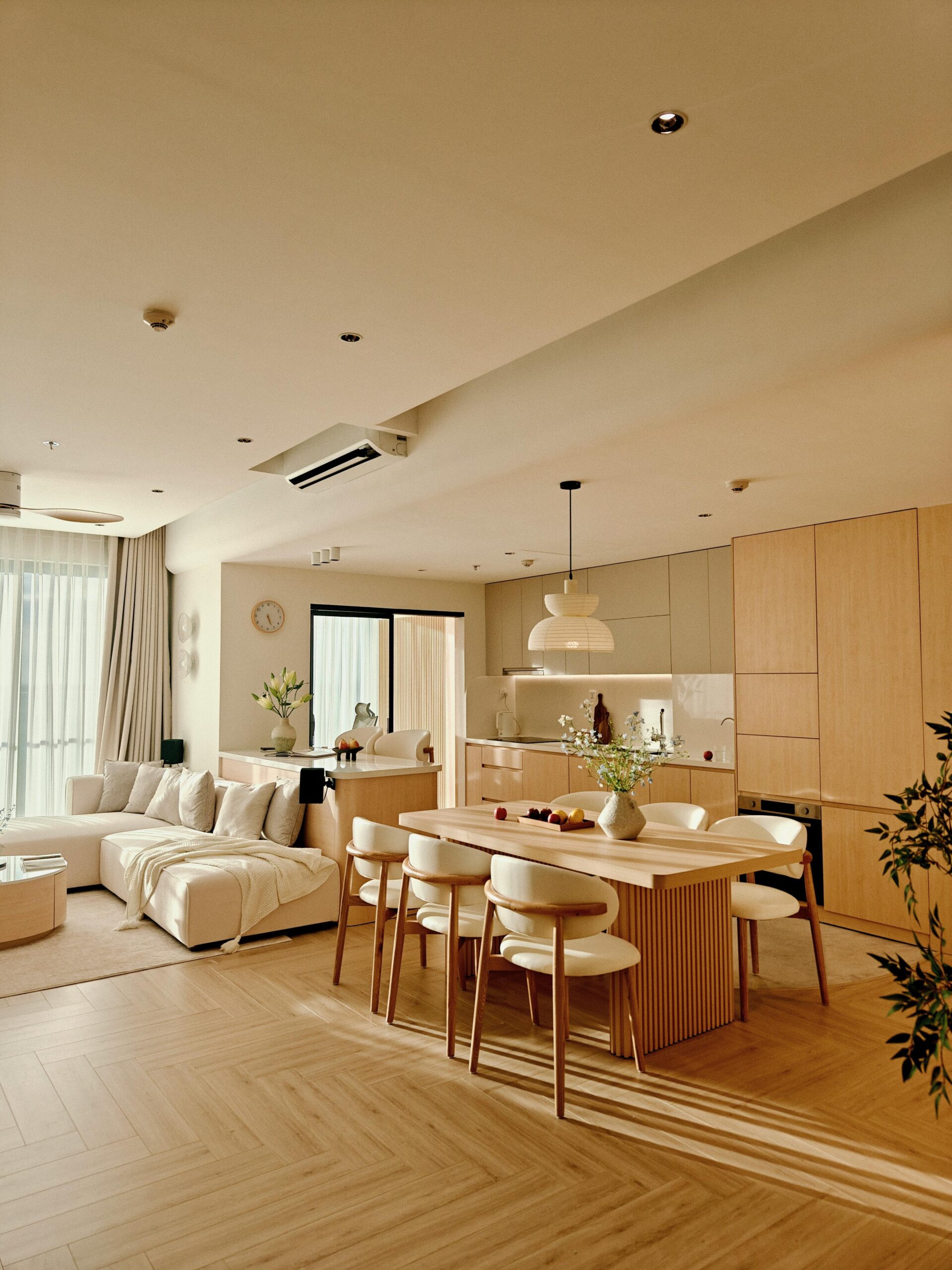 Bright, minimalist living room with wooden accents in Vietnam, offering serene elegance.